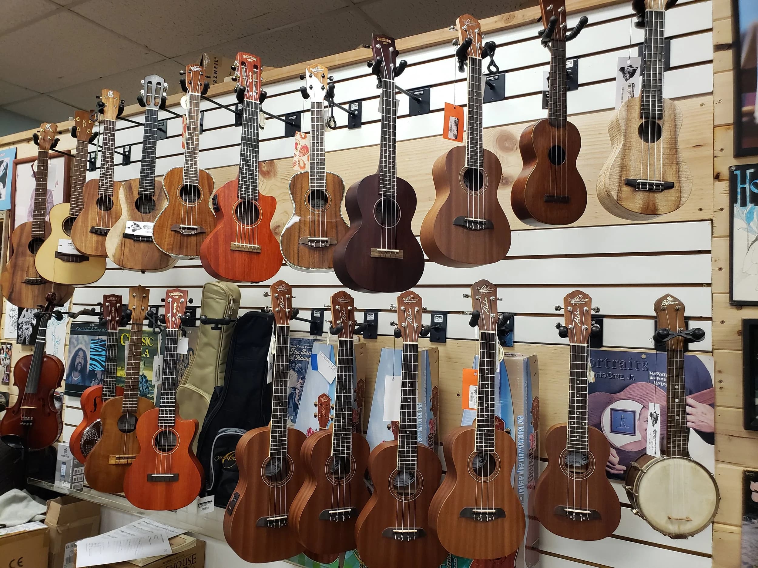 The ukulele wall at Big Island Guitars, from koa customs to starter ukes