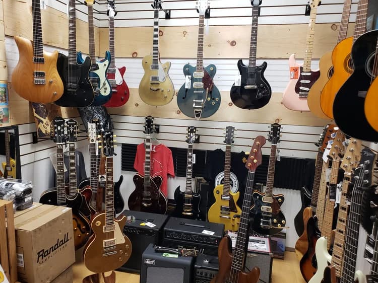 Gear on the wall at Big Island Guitars in Hilo, ready to go home with you
