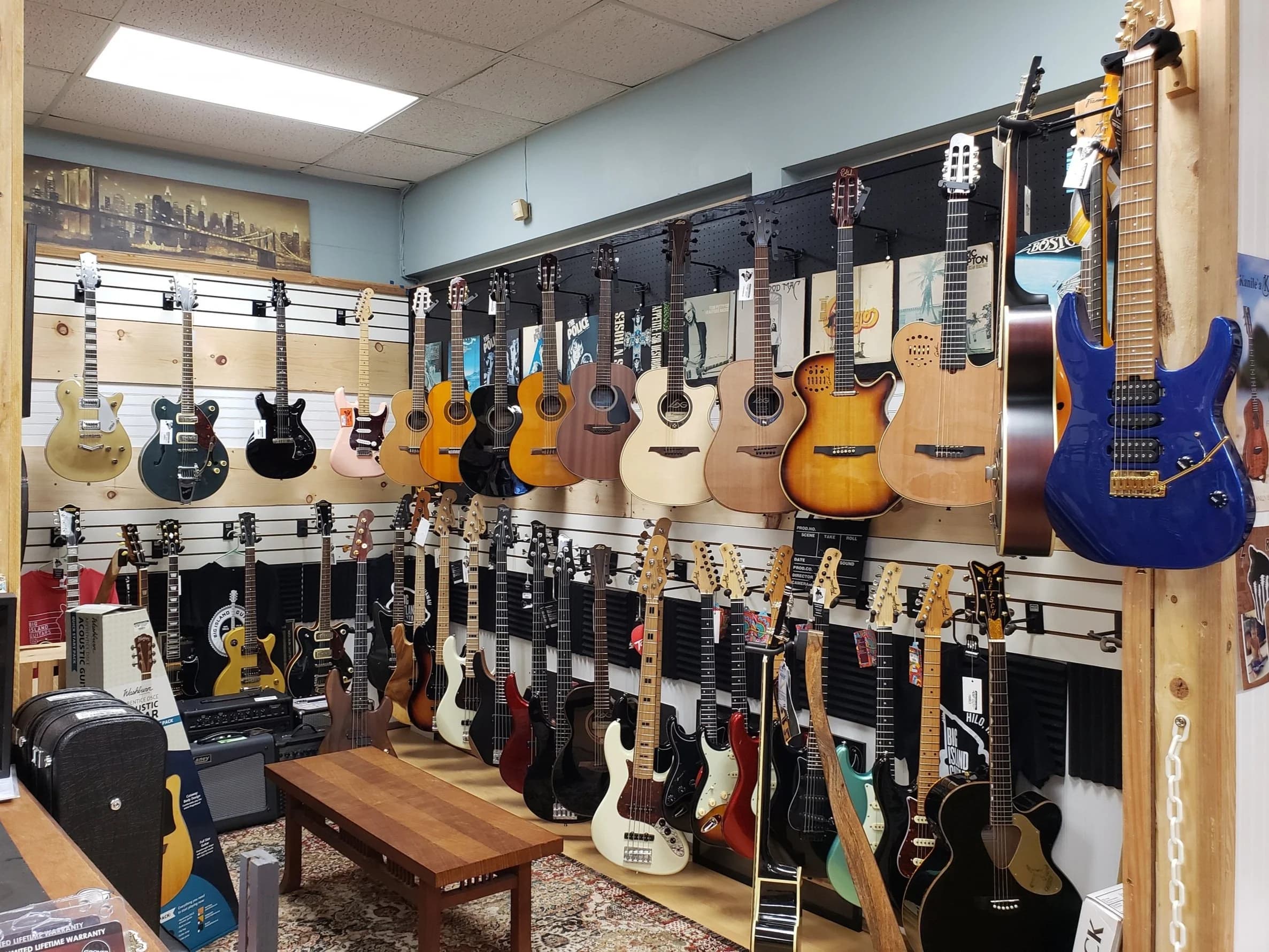 Walls of electric and acoustic guitars at Big Island Guitars in Hilo